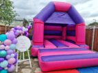 pink purple bouncy castle image 5 min